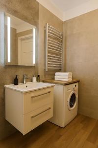 a bathroom with a washing machine and a sink at Apartament 1go Maja TK in Namysłów +10 photos