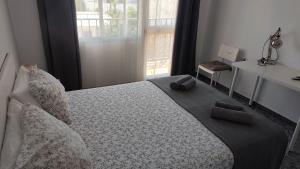 a bedroom with a large bed with pillows on it at BNB LOLA - Habitacion con Baño privado en el pasillo y aire acondicionado in Puerto Real