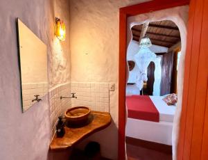 a bathroom with a sink and a bed in a room at Pousada Cavallitos d'Amar in Ilha de Boipeba +83 photos