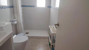 a white bathroom with a toilet and a shower at BNB LOLA - Habitacion con Baño privado en el pasillo y aire acondicionado in Puerto Real