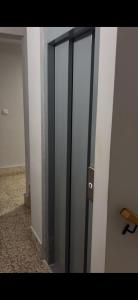 a glass door in a room next to a wall at Argentina 32 in Ayora