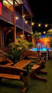 a group of wooden benches in front of a building at Hotelito Villas Holbox - Self Check In in Holbox Island +29 photos