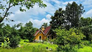 a small house in the middle of a field at StoneHaven 1BHK pvt Pool in Agashi