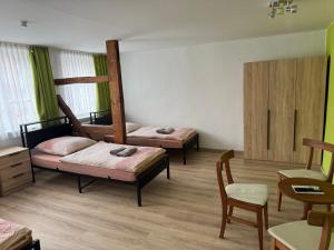 a room with two bunk beds and a table at Monteurhaus Salzwedel in Salzwedel