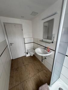 a small bathroom with a toilet and a sink at Monteurhaus Salzwedel in Salzwedel