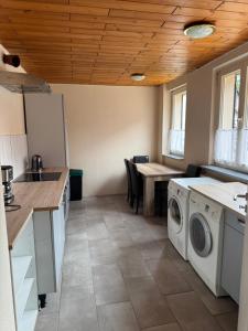 a kitchen with a washer and dryer in it at Monteurhaus Salzwedel in Salzwedel +7 photos