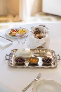 a tray of food on a table with a plate of food at Palazzo Venneri Lloyd - Historic Heritage Palazzo in Gallipoli