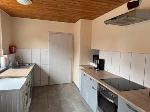 a kitchen with white cabinets and a counter top at Monteurhaus Salzwedel in Salzwedel