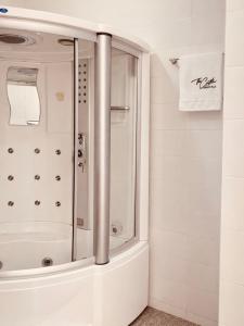 a shower with a glass door in a bathroom at The Castle Private Villa in Aso