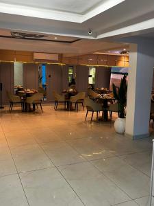 a dining room with tables and chairs in a restaurant at DE-WILLIAMS PLACE hotel in Ibadan