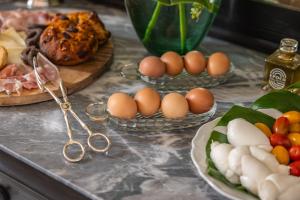a table with eggs and vegetables and pairs of scissors at Palazzo Venneri Lloyd - Historic Heritage Palazzo in Gallipoli +65 photos
