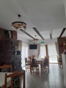 a dining room with a table and chairs at Cabana Andrea in Arpaşu de Sus