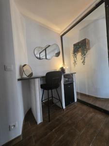 a room with a desk with a chair and a lamp at L'Ecrin Vert & Spa in Kaysersberg +29 photos