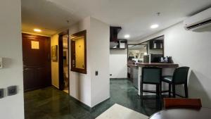 a kitchen with a table and chairs in a room at EXECUTIVE SUITES VALENCIA-Venezuela in Valencia +56 photos