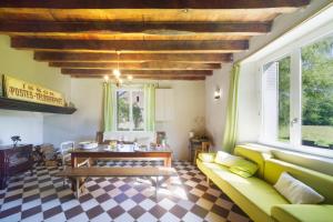 a living room with a couch and a table at Chez Sylvain in Issor