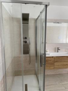 a glass shower in a bathroom with a sink at La Casa di PAT in Campobasso +12 photos