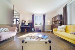 a living room with two couches and a coffee table at Chez Sylvain in Issor