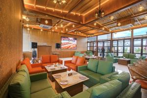 a restaurant with green and orange chairs and tables at The Roseville Grand Near Chandigarh University-Rayat Bahra University Kharar Chandigarh in Kharar