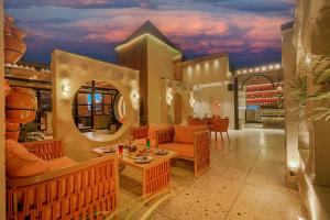 a living room with orange furniture and a table at The Roseville Grand Near Chandigarh University-Rayat Bahra University Kharar Chandigarh in Kharar