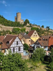 a town with a castle on top of a hill at L'Ecrin Vert & Spa in Kaysersberg