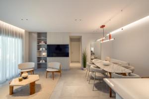 a living room with a table and chairs at Villa Occasus by A&D Properties in Porto Rafti