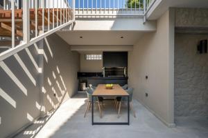 a kitchen and dining room with a table and chairs at Villa Occasus by A&D Properties in Porto Rafti +48 photos