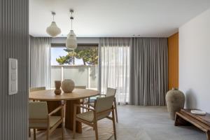 a dining room with a table and chairs at Villa Occasus by A&D Properties in Porto Rafti