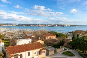 an aerial view of a city with a marina at "LE PANORAMIQUE" en plein centre in Port-de-Bouc