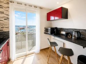 a kitchen with a microwave and a window with a view at "LE PANORAMIQUE" en plein centre in Port-de-Bouc