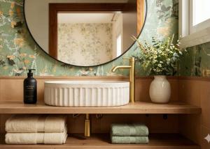 a bathroom with a sink and a mirror and towels at Alquilaeasy Marbella Views Ojen in Ojén