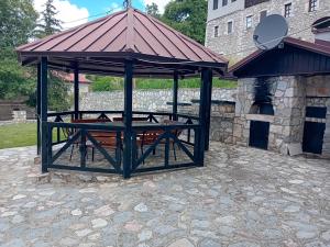 a gazebo with a picnic table on a patio at Villa Galicnik in Galičnik