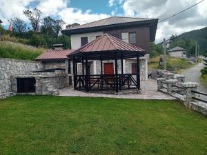 a house with a gazebo in the yard at Villa Galicnik in Galičnik
