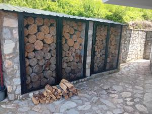a pile of fire wood next to a wall at Villa Galicnik in Galičnik