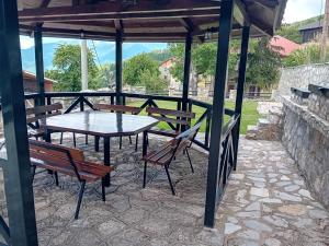 a picnic table and chairs under a pavilion at Villa Galicnik in Galičnik