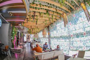 a restaurant with people sitting at tables in front of a wall at Royal Court Hotel in Ramallah