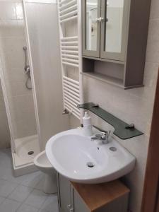 a white bathroom with a sink and a toilet at I 23 PASSI Alfedena in Alfedena