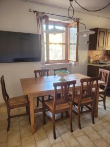 a kitchen with a wooden table with chairs and a dining room at I 23 PASSI Alfedena in Alfedena +20 photos