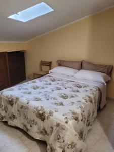 a bedroom with a large bed with a white blanket at I 23 PASSI Alfedena in Alfedena