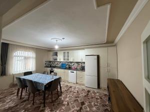 a kitchen with a table and chairs in a room at Kır Home in Çaykara