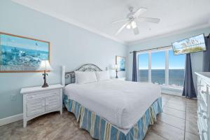 a bedroom with a bed and a view of the ocean at Dolphin Key 3C in Orange Beach