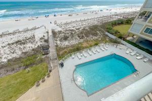 an overhead view of a pool and the beach at Dolphin Key 3C in Orange Beach