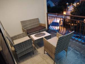 a balcony with two chairs and a table and a table and chairs at Apartmani Medo in Risan