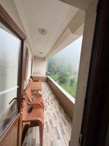 a room with several chairs and a large window at Kır Home in Çaykara +2 photos