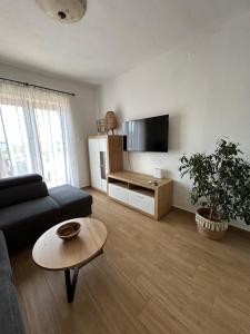 a living room with a couch and a table at Apartment Roko (10m from the beach) in Pašman