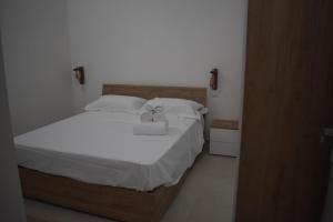 a bedroom with a bed with a stuffed animal on it at Terrazza sul Borgo in Polignano a Mare