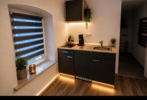 a kitchen with a sink and a window at Ferienwohung M&A in Kulz