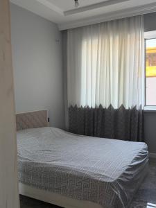 a bedroom with a bed in front of a window at Sunset Garden Apartment 3 in Bilgah +22 photos