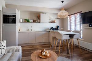 a kitchen and living room with a table and chairs at Luxury Apartment Knokke-Heist in Knokke-Heist +8 photos