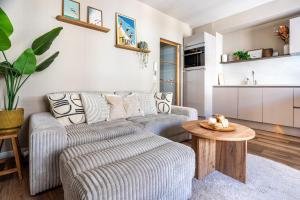 a living room with a couch and a table at Luxury Apartment Knokke-Heist in Knokke-Heist