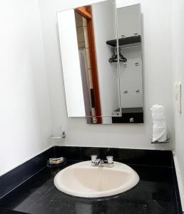 a bathroom with a white sink and a mirror at Regency Plaza Hotel in Pisco +13 photos
